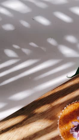 cupcake and flowers on a wooden board