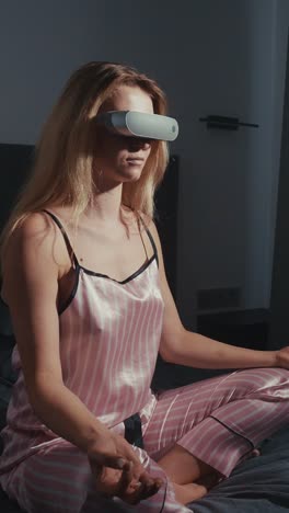 woman meditating with vr headset in pajamas