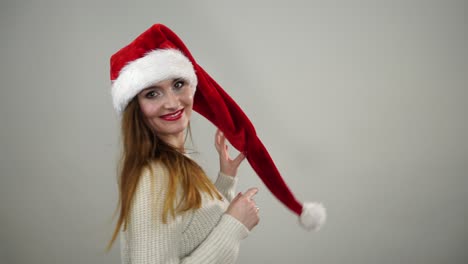 woman playing with santa claus helper hat 4k.