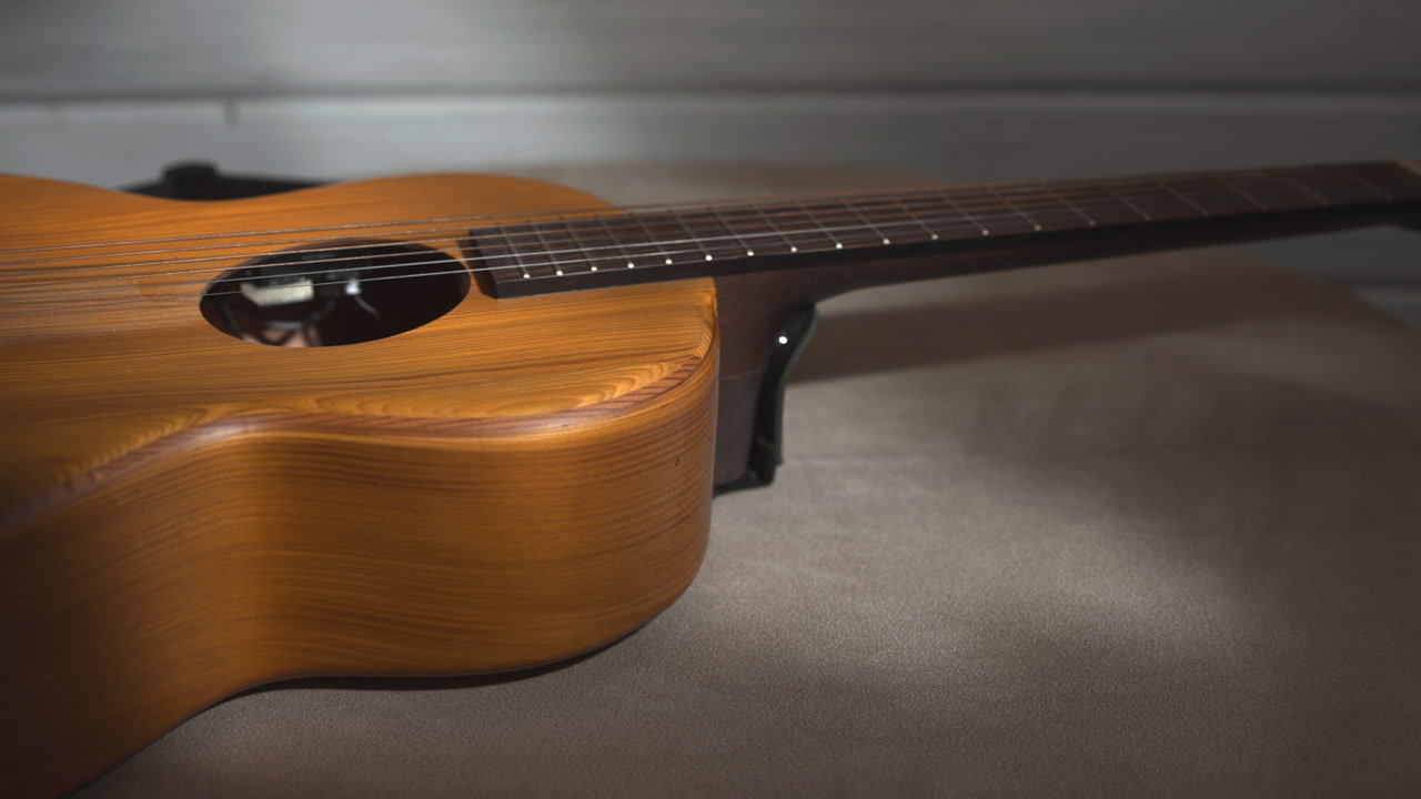 Closeup Acoustic Guitar Neck And Body, Warm Low Key Lighting, Visible Mahogany Grain, Shallow Depth Of Field, . Media