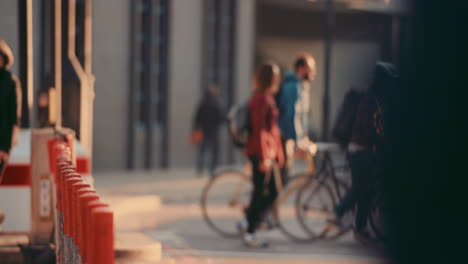 anonymous crowd of people walking cycling bicycles commuters london city street slow motion
