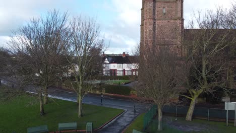 Aerial-rising-above-industrial-small-town-frosty-church-rooftops-neighbourhood-North-West-England