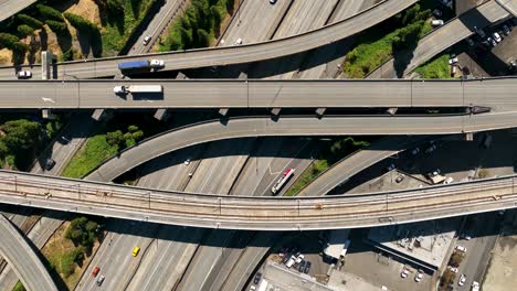 top down drone shot of traffic passing through seattle's freeway system on a sunny day