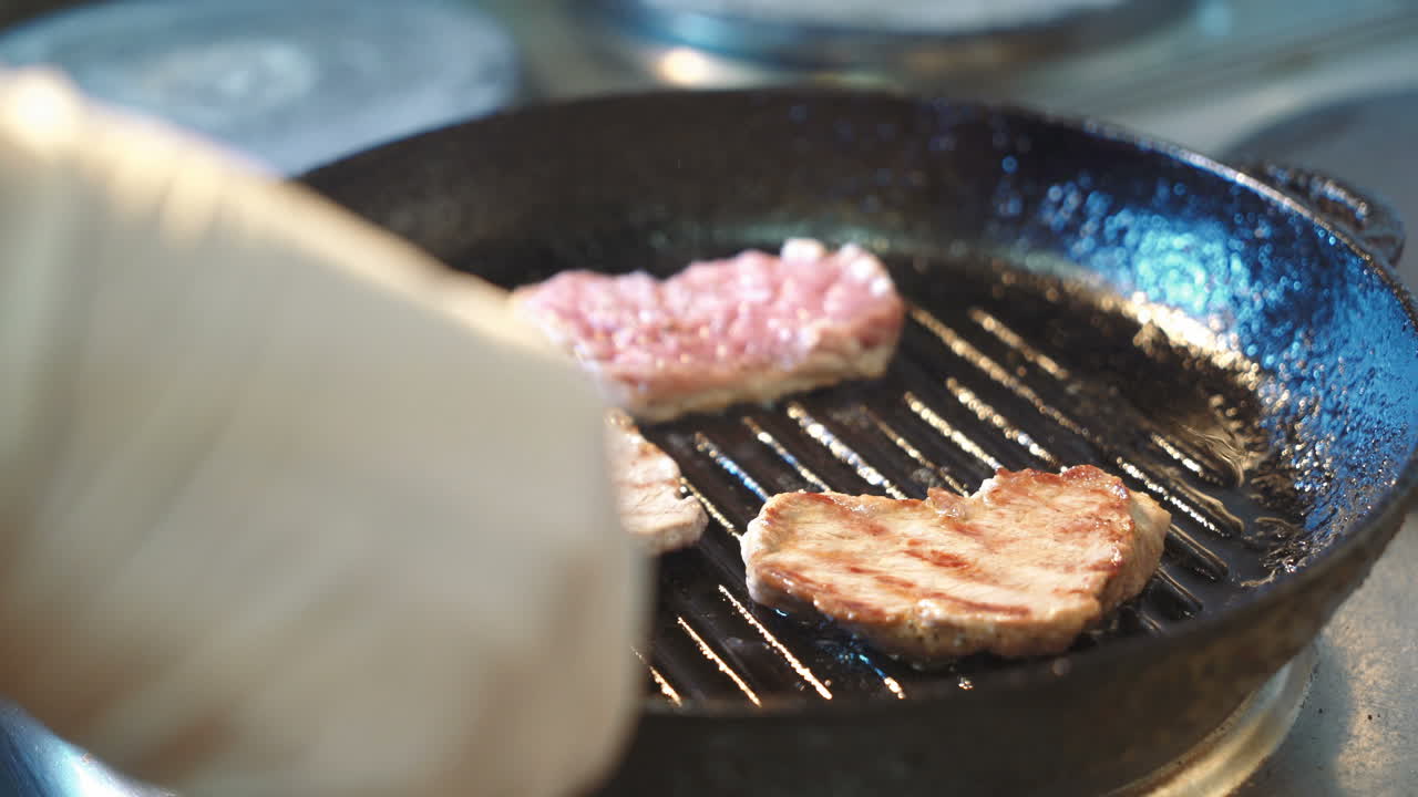 Seasoned sirloin steak in griddle pan.