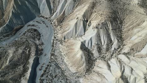 Drone-view-of-dry-rough-terrain-with-rocky-formations