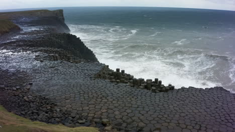giant's causeway basalt columns and crashing waves