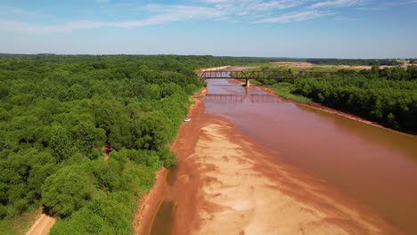 Aerial-footage-of-a-white-truck-stuck-in-mud-on-the-Red-River-in-Texas