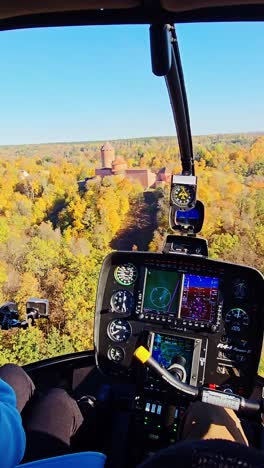 low-altitude aerial view of vibrant autumn forest and historic sigulda castle