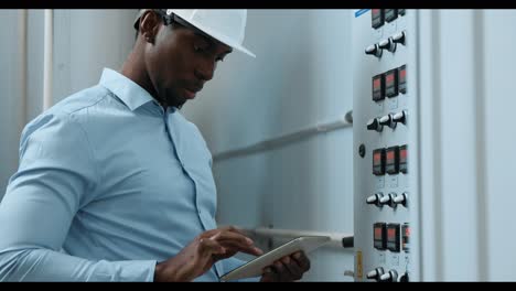 engineer monitoring industrial control panel