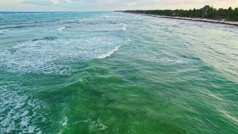 aerial drone view of mexican beach surf spot with high tide low waves during evening sunset