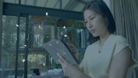 animation of currency signs, network and data processing over asian woman using tablet