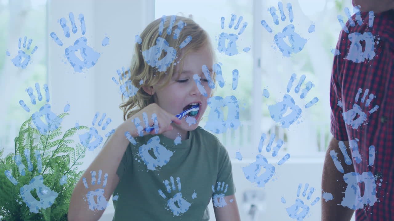 Video of handprints over caucasian boy brushing teeth