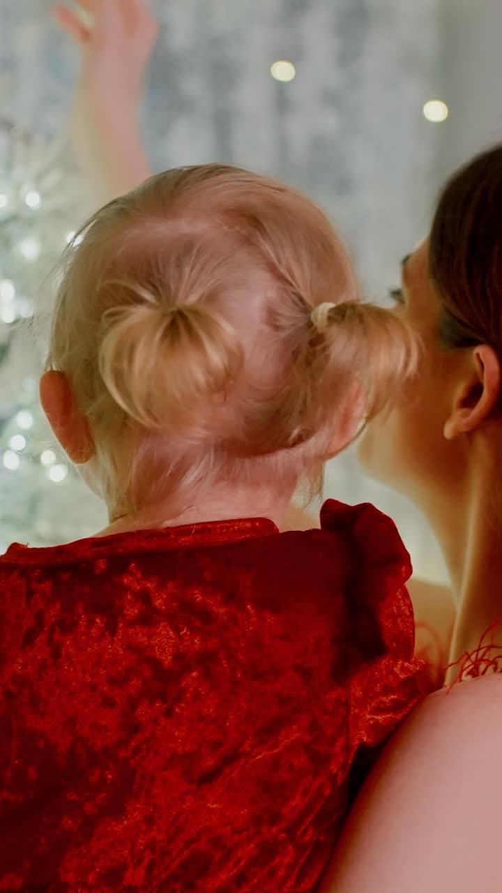 A Magical Moment: A Child and Mother Admiring a Twinkling Christmas Tree Together, Joyful Expressions, and Heartwarming Connection Captured in a Beautiful Festive Setting of Holiday Cheer