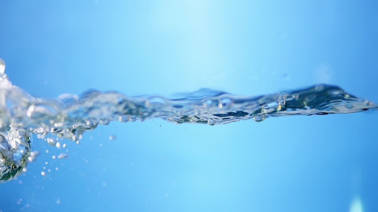 Fresh water bubbles rise from below, creating ripples and waves that symbolize cleanliness, purity, and the fluid motion of nature.