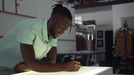 mixed race man working in fashion office