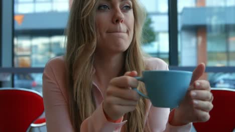 pretty blonde having a coffee in cafe