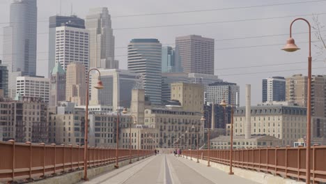 downtown minneapolis from stone arch bridge in minneapolis, minnesota. - wide shot