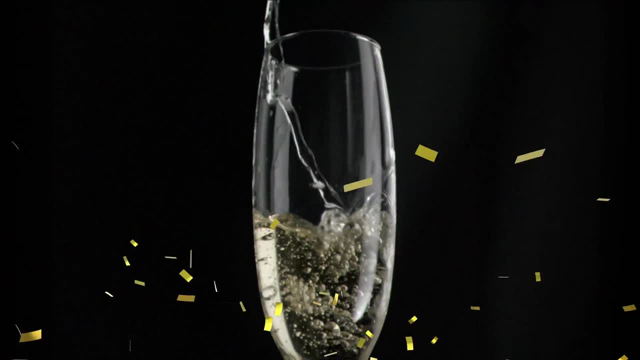 검은색 바탕에  ⁇ 페인 잔 위에 떨어지는 금색 콘페티의 애니메이션