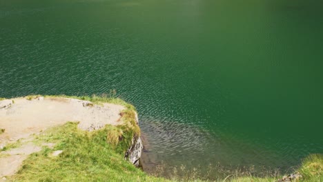 emerald calm water of balea lake revealed steep rocky valley near transfagaras in romania