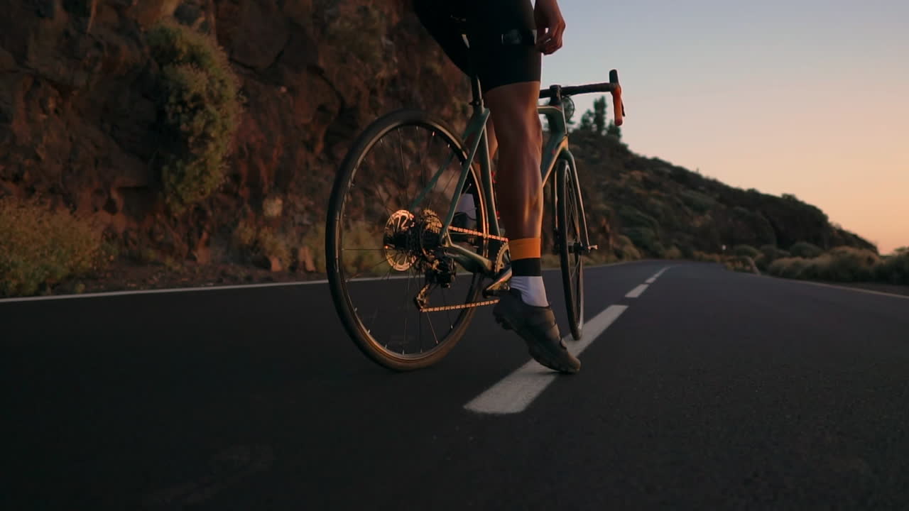 In slow motion, the athlete on a bike makes his way along a mountain serpentine, feasting his eyes on the island's captivating view, epitomizing a healthy lifestyle