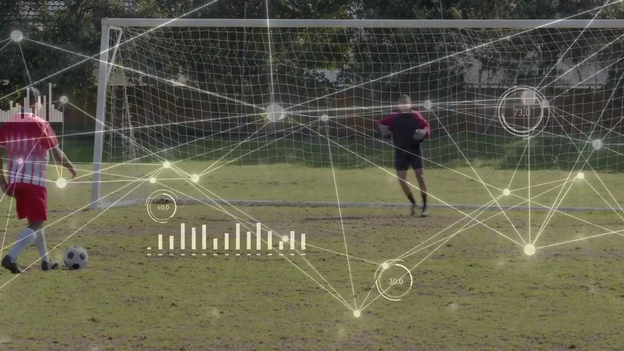 Soccer player in red kit placing ball running striking aiming goal while keeper diving HUD overlay