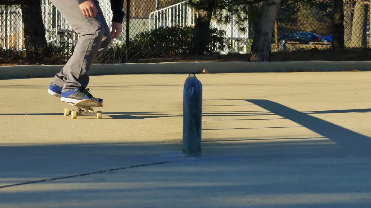 Skater does a trick on a rail at the skate park