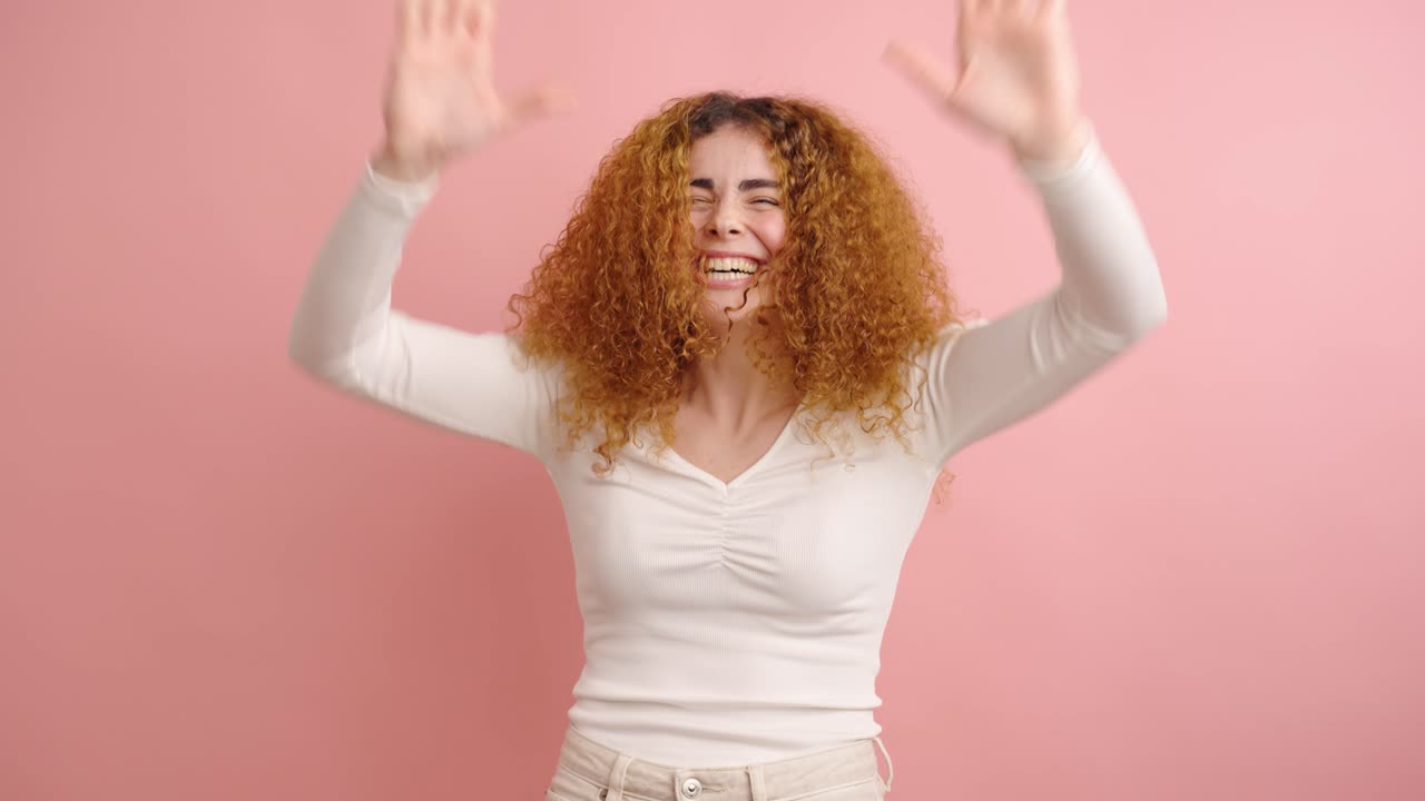 Young woman expressing joy and excitement in studio setting