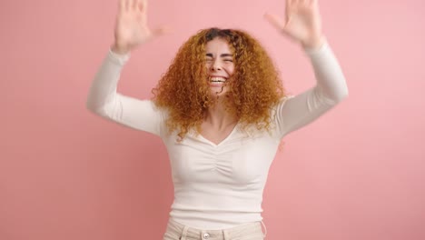 young woman expressing joy and excitement in studio setting