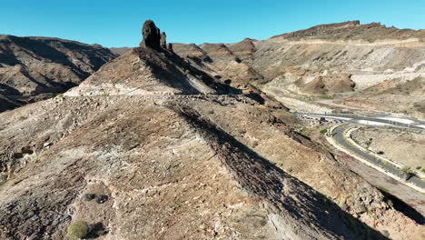 Panoramic-aerial-shot-of-the-rock-formation-known-as-El-Camello-and-located-near-the-Medio-Almud-beach,-on-the-island-of-Gran-Canaria