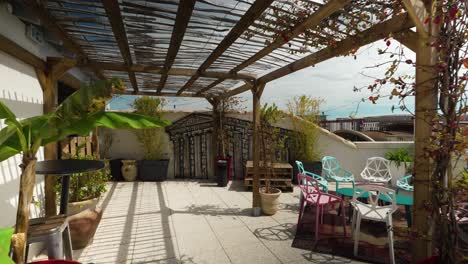 POV-shot-of-beautiful-rooftop-with-in-house-plants-and-seating-area-with-wall-art