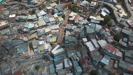 drone aerial flying over comuna 13 slums in medellin city, colombia, south america