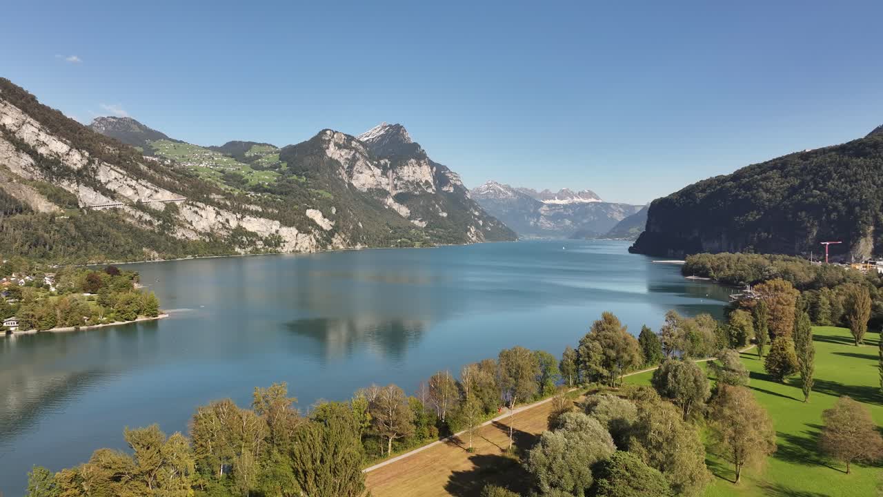 A captivating aerial view reveals Lake Walensee, framed by the charming landscape of Weesen, Glarus, Switzerland.