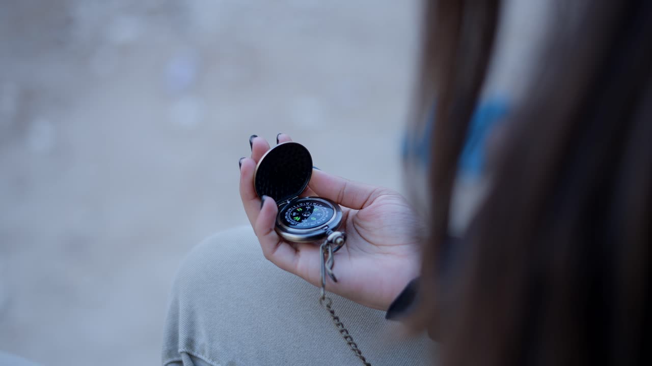 Woman Holding a Pocket Compass