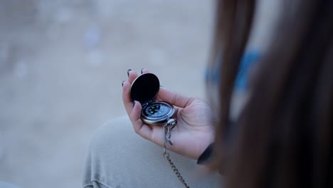 woman holding a pocket compass