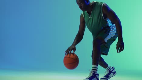 video of african american male basketball player bouncing ball on blue background