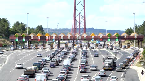 cars passing through the point of toll highway, toll station near the bridge. lisbon, portugal