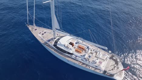 aerial top down shot of luxury sailing yacht on blue sea during sunny day - oyster new florida