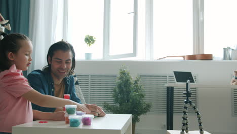 father and daughter playing with slime