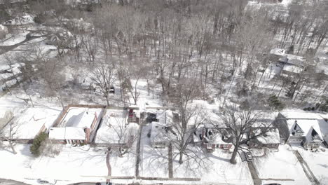 Slow-push-over-houses-in-suburban-neighborhood-on-a-snowy-day