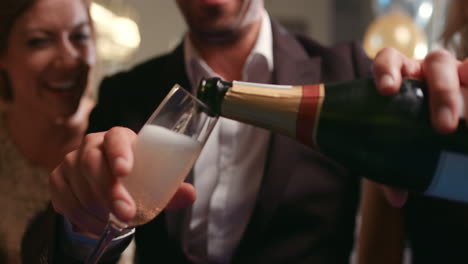 friends holding up champagne flutes together in a toast at party