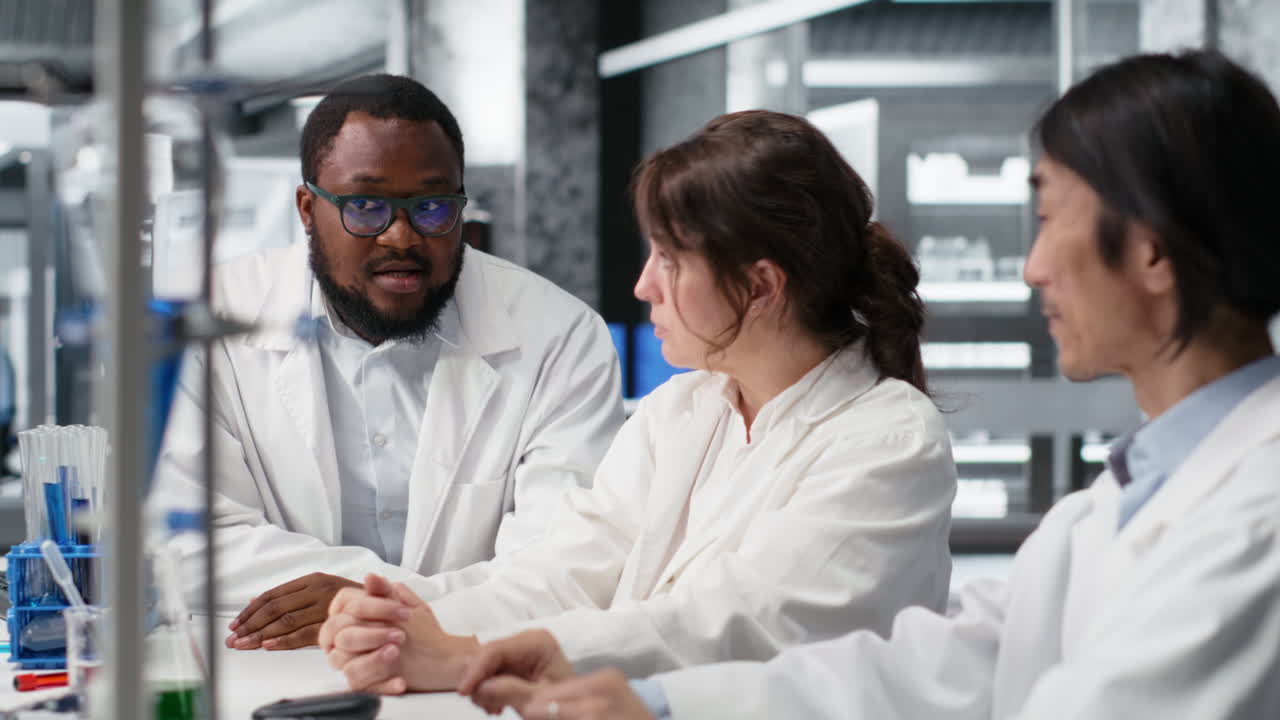 Vertical video Diverse team of research facility professional using PC software