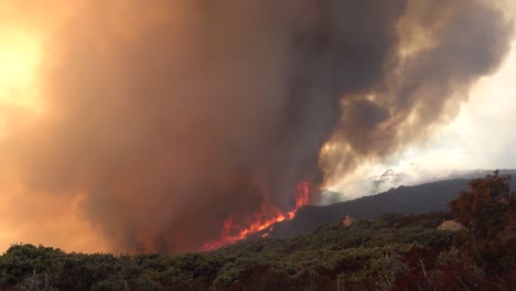 a vast and fast moving wildifre burns as a huge brush fire on the hillsides of southern california during the cave fire in santa barbara