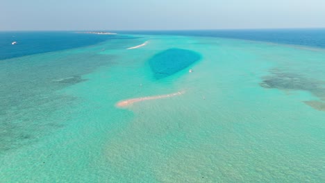 an awe-inspiring aerial drone view captures the rasdhoo sandbanks glowing under the soft, golden light of sunset in the maldives.