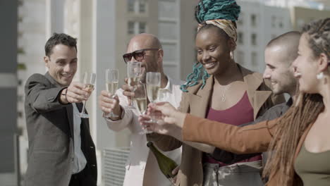 happy coworkers toasting with sparkling wine