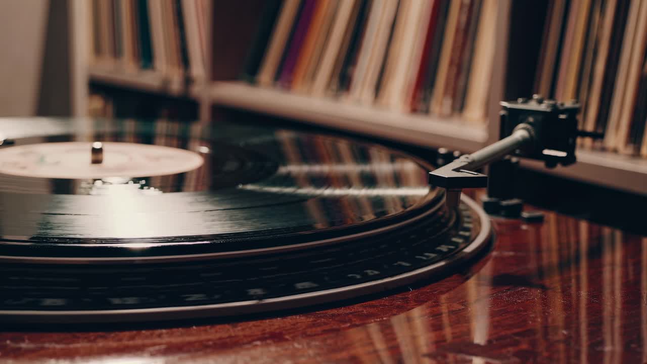 Close-up, angled shot of a spinning vinyl record on a turntable, capturing a nostalgic, vintage