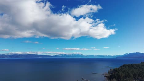 drone shot panning to the right and down of lake tahoe on a sun filled day