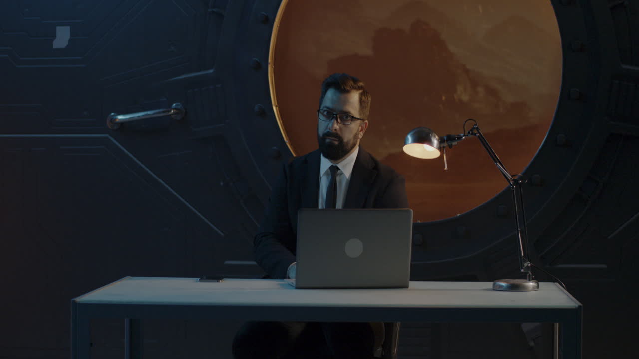 Businessman Working on Laptop in Futuristic Space Office