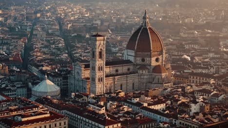 aerial retreating descend pan up over florence duomo, revealing the grand cityscape and warm morning light