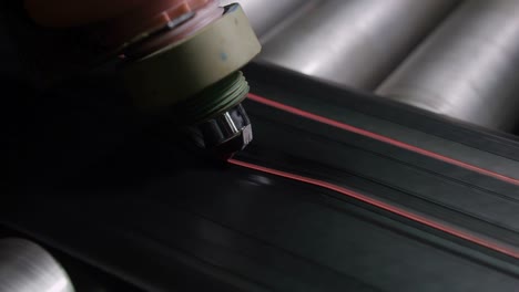 machine makes red marking on tyre rubber macro
