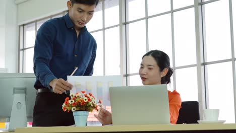 two business people talk project strategy at office